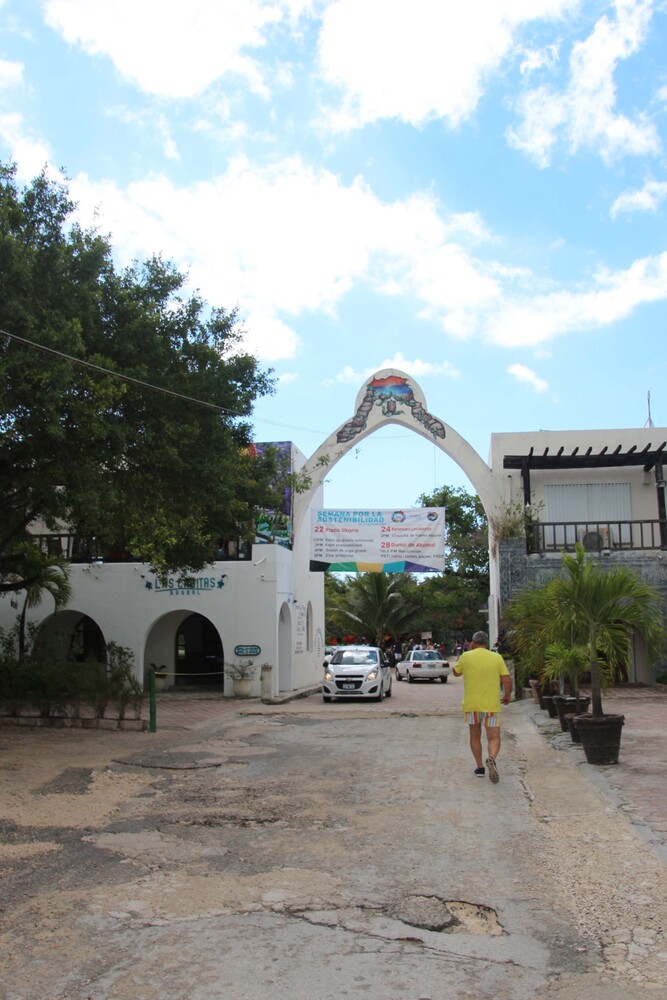 Walk trough the white gate to get to the beach